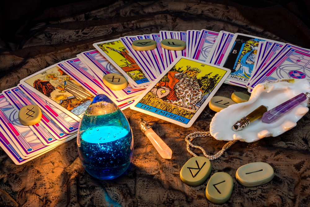 Tarot cards and runes by candlelight in the evening.