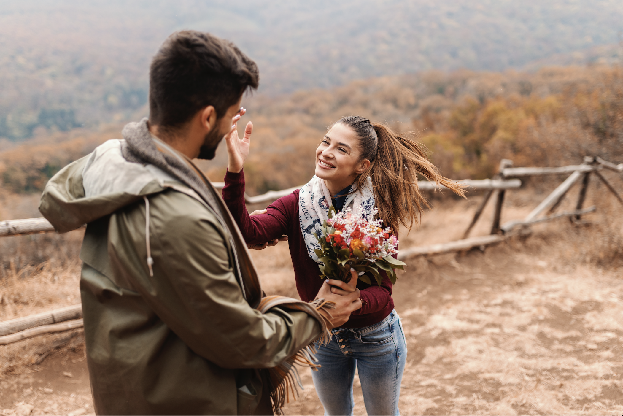 A man gifts his partner with flowers