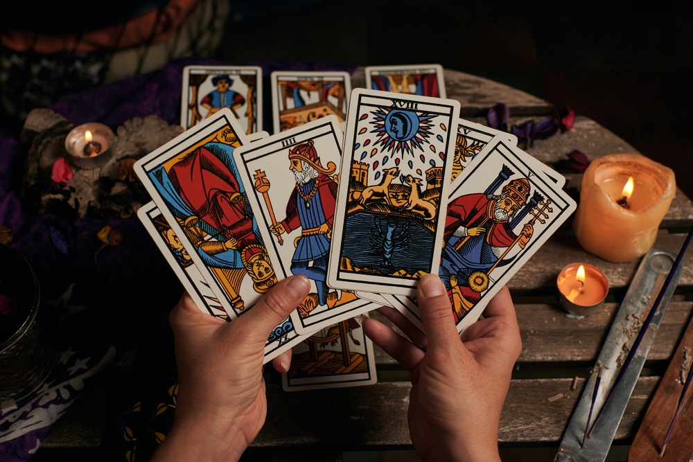 Close-up of a fortune teller reading tarot cards.