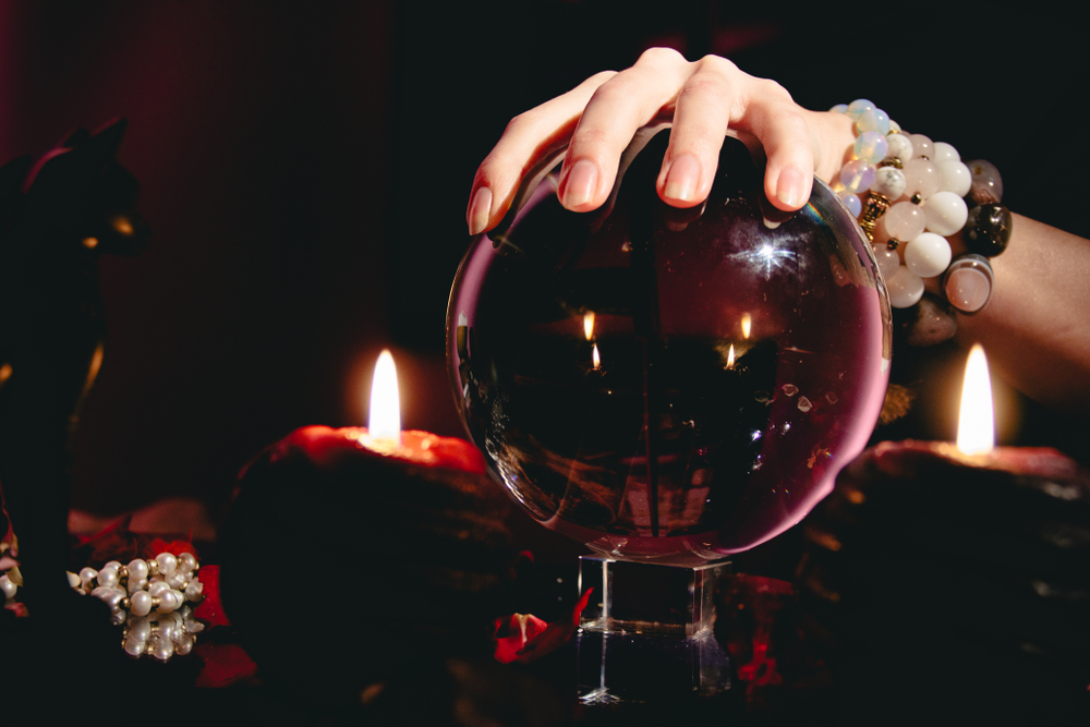 Fortuneteller's hand on a glass orb. Prediction of the future.