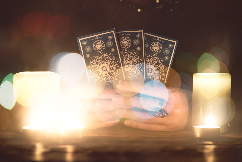 Fortune teller with tarot cards in hands close up. Future reading concept.